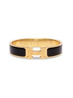 Brazalete Hermès con esmalte negro y herraje dorado